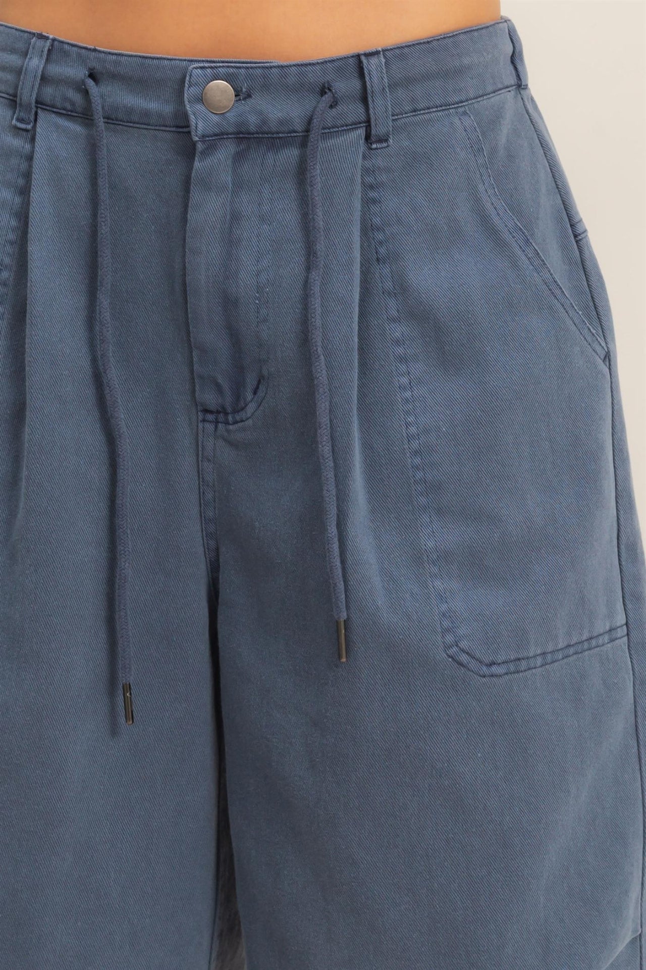 Close-up of navy jorts drawstring and hardware