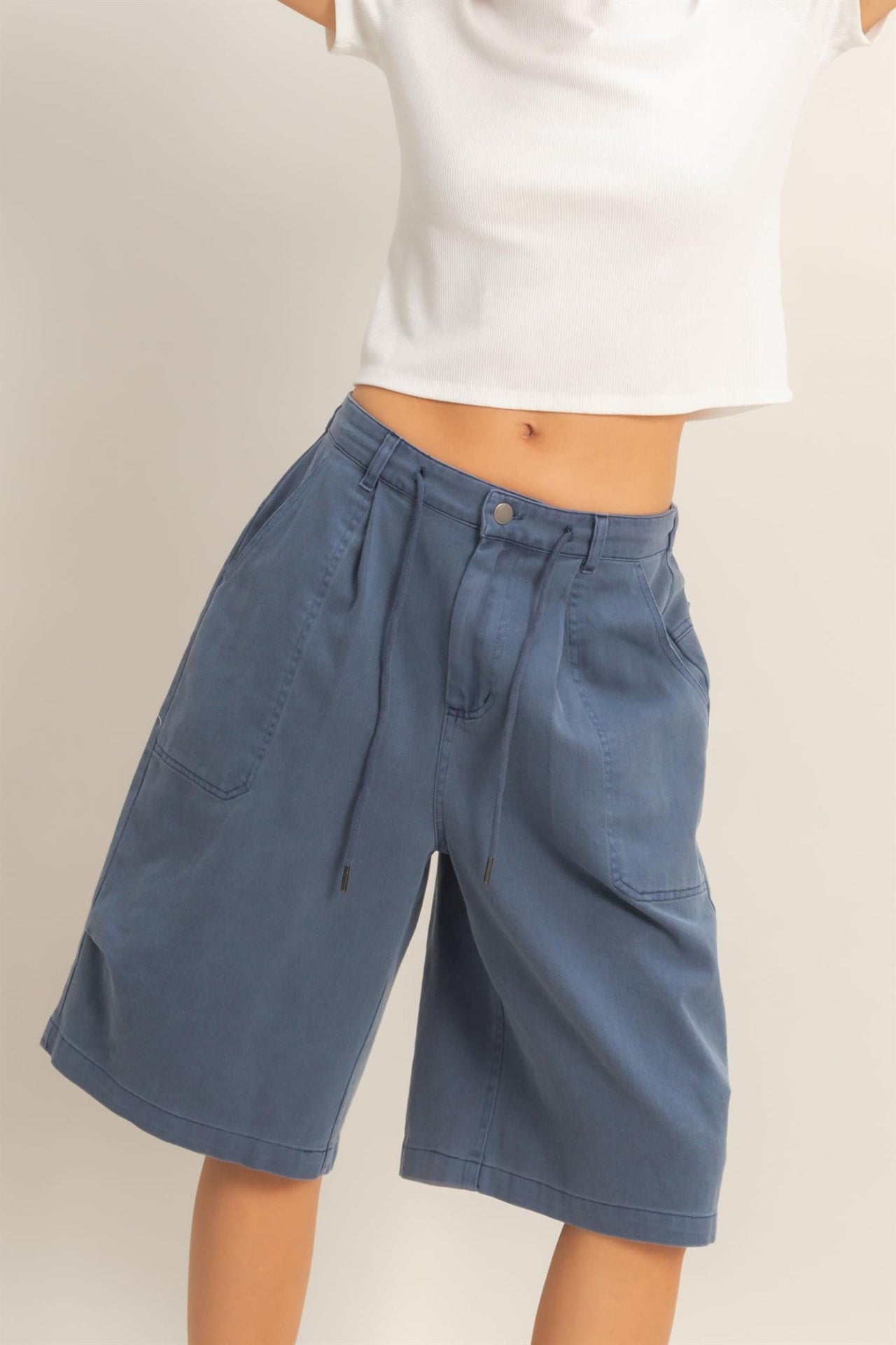 Navy cotton drawstring jorts, front view on model